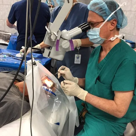 Dr. Perlman performing eye surgery during a medical mission