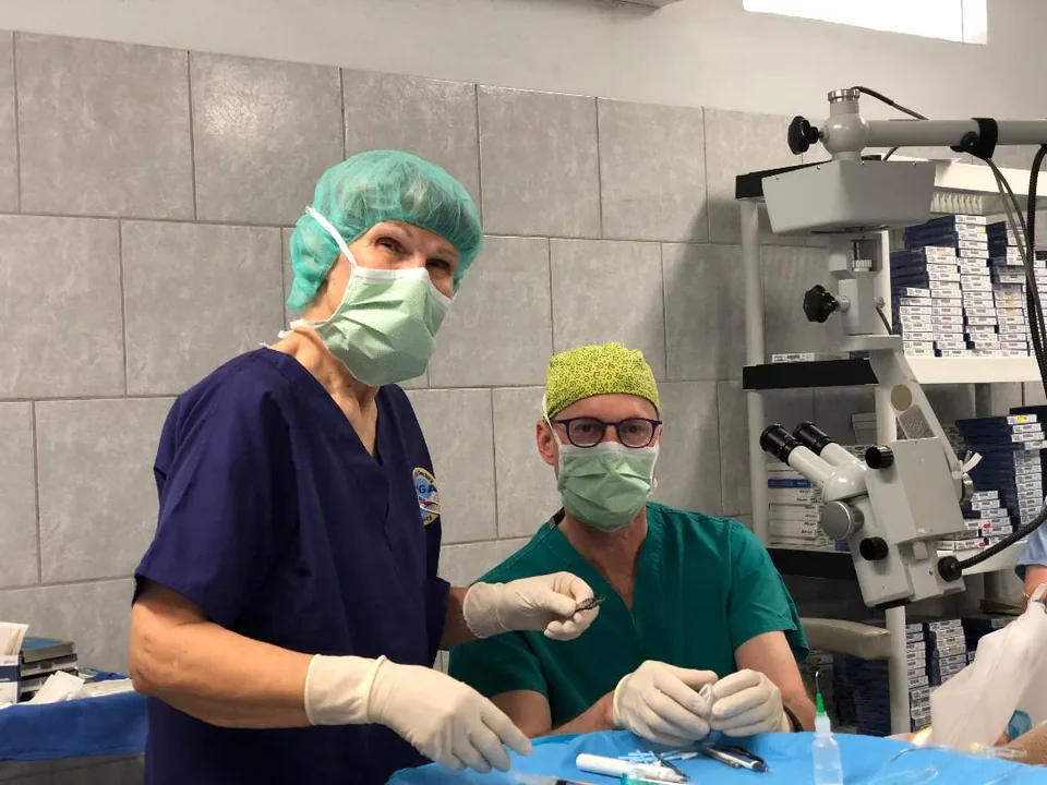 Two surgeons in masks at work in a mission operating room